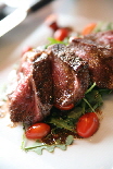 a_grilled_strip_on_bed_of_arugula_1